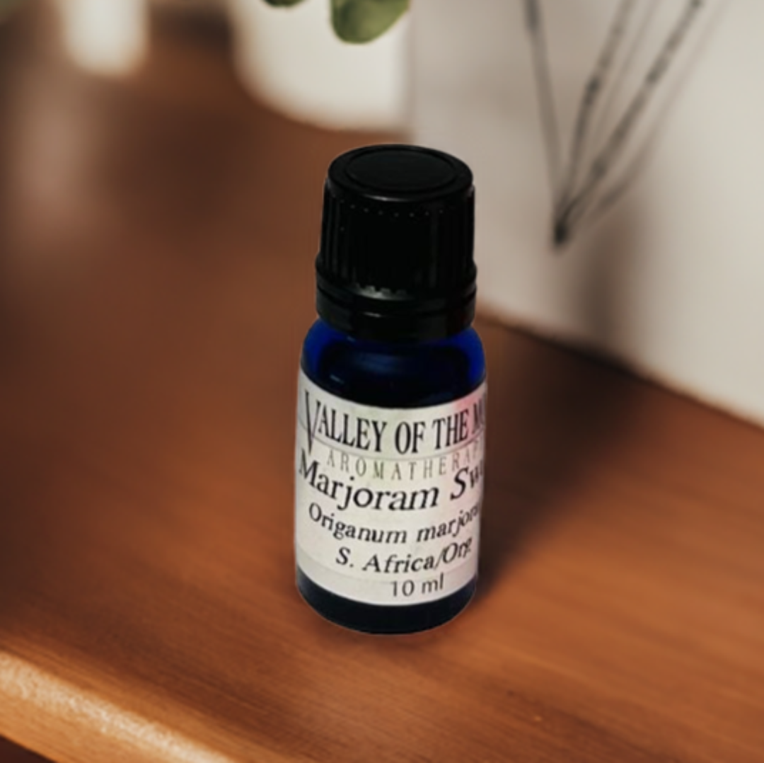 Valley of the Moon Aromatherapy Majoram Sweet blue bottle on a wooden surface