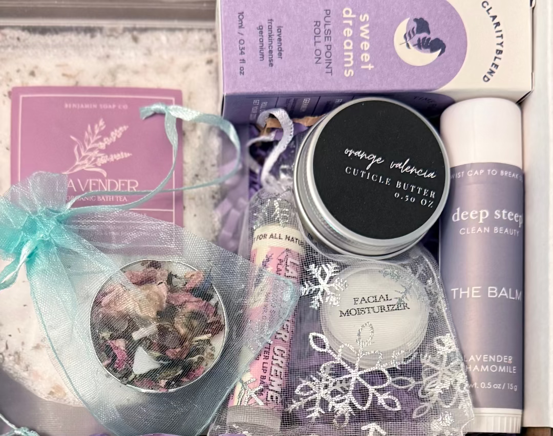 Collection of skincare and beauty products with visible branding on a textured surface.