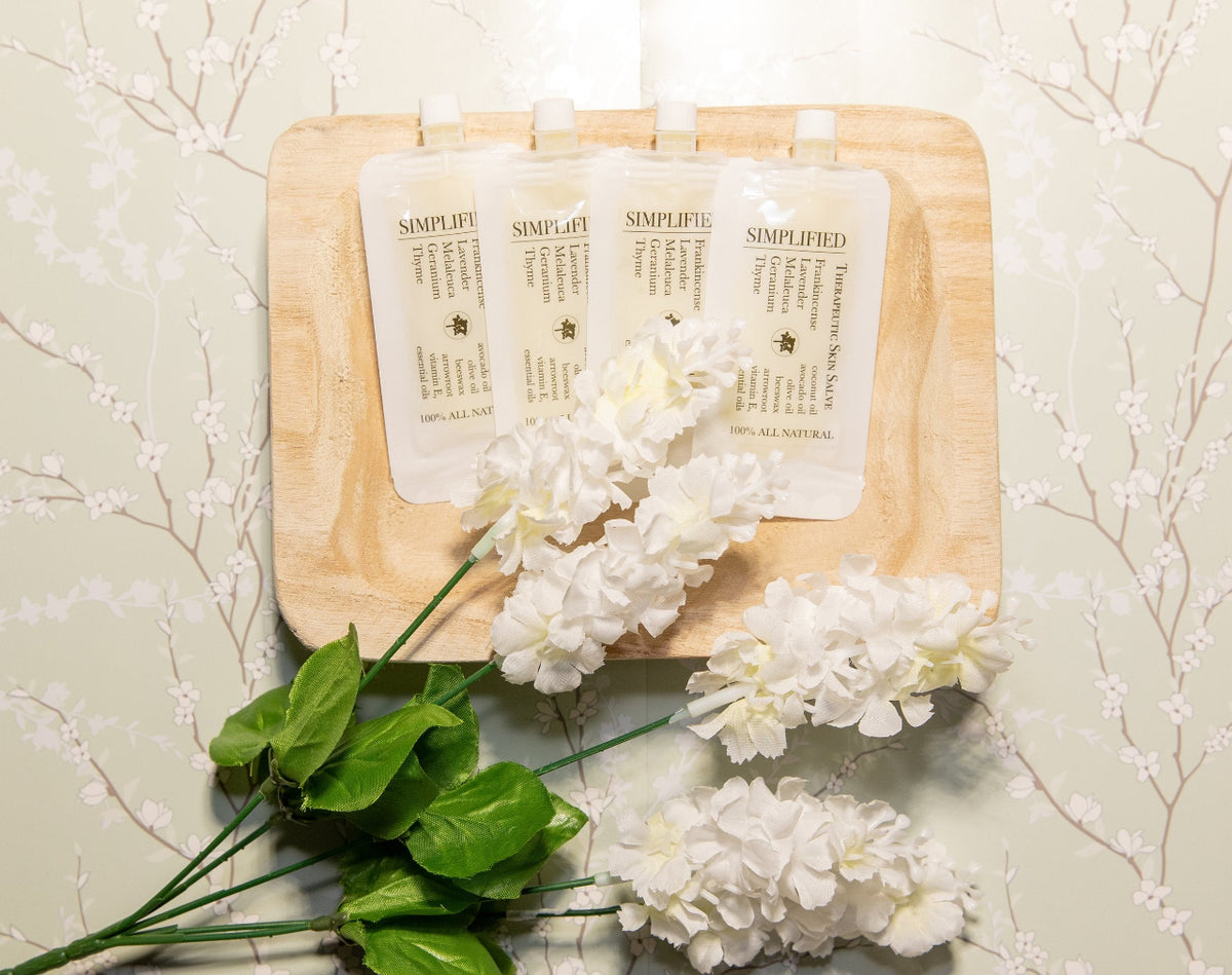 A pouch of 'Therapeutic Skin Salve' with a label that includes an list of ingredients and a definition of the product.